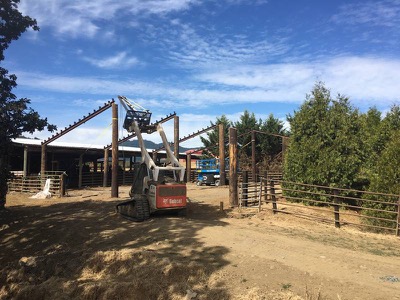 Large barn under construction using reclaimed telephone poles
